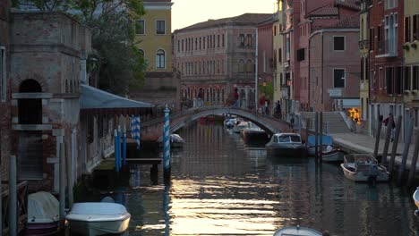 Italians-Walking-on-Arch-Stone-Bridge-over-Canal-in-Venice