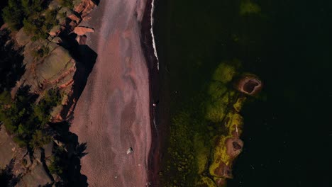Birds-eye-drone-shot-over-the-Iron-beach,-sunny,-summer-day-in-Jussaro,-Finland