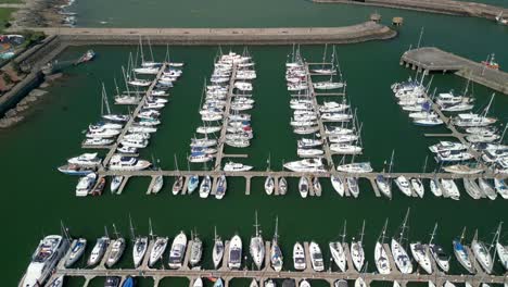 Overhead-aerial-shot,-beginning-close-and-moving-away-from-boats-on-a-marina-on-a-sunny-day