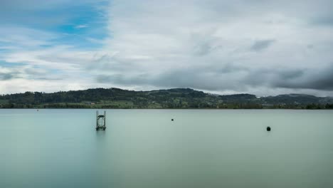 Time-lapse-under-a-cloudy-sky-at-lake-called-Pfäffikersee-in-Switzerland