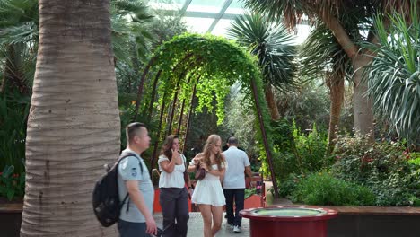 People-walking-into-the-Mediterranean-Garden-in-the-landmark-attraction,-world-largest-glass-greenhouse-Flower-Dome-conservatory-at-Gardens-by-the-bay
