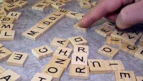 Tabletop-crossword-of-MIDDLE-and-EAST-formed-with-Scrabble-letters