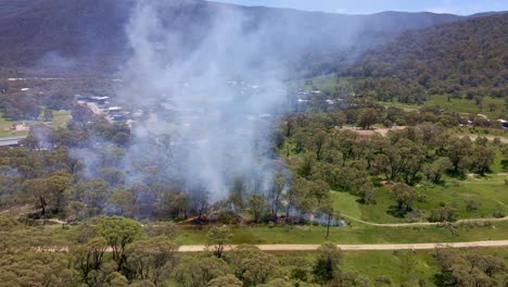 Toma-Aérea-Hacia-Atrás-De-Un-Incendio-Atrapado-En-Un-Crackenback-Que-Genera-Humo-En-Nueva-Gales-Del-Sur,-Australia