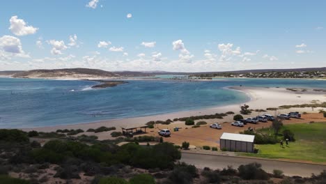 Drone-aerial-moving-forward-over-Kalbarri-lagoon-from-a-carpark-on-a-sunny-day