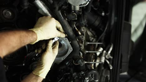Car-Mechanic-Hands-In-Gloves-Working-At-Auto-Repair-Shop