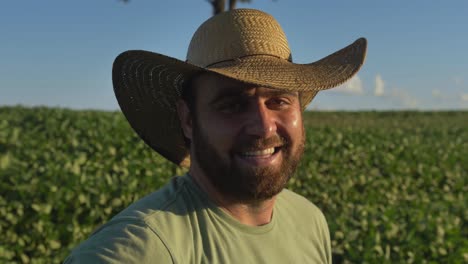 close-up-footage-of-a-soybean-farmer-man-with-a-country-hat-on-a-soybean-plantation---countryside-of-Brazil