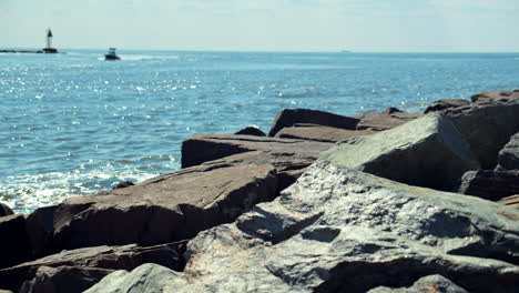 Boat-Drifts-into-New-Jersey-Harbor-over-Bright-Rigid-Stones