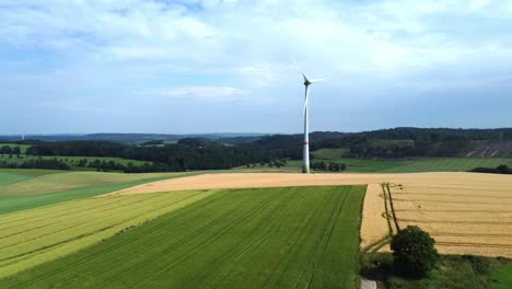 Wind-turbines-on-green-field-in-countryside,-aerial-view