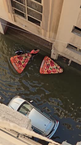 On-April-19,-2024,-grocery-supplies-are-being-delivered-using-a-small-boat-through-a-flooded-road-in-the-northern-Emirates-of-the-UAE