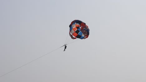 parasailing-adventure-activity-with-bright-blue-sky-background-at-day-from-flat-angle