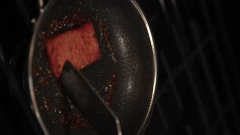 Cooking-SPAM-Meat-in-Stainless-Steel-Pan,-Close-up-Vertical