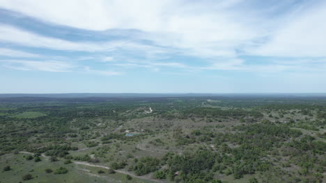 Aerial-view-of-rural-ranch-land-in-the-Texas-Hill-Country,-wide-angle