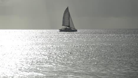 sail-boat-sailing-the-Caribbean-Sea-in-barbados-island-at-sunset