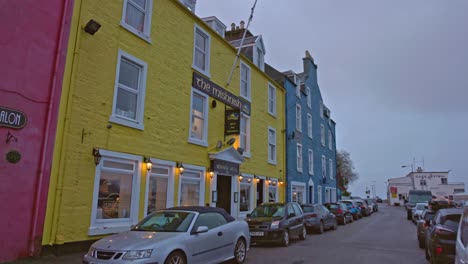 POV-establishing-shot-of-the-famous-colourful-building-on-the-Tobermory-seafront