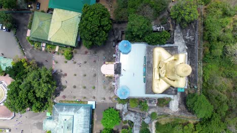 Aerial-drone-view-of-Golden-Temple-of-Dambulla-with-giant-Buddhist-sacred-Buddha-statue-royal-temple-building-in-Sri-Lanka-religion-spirituality-travel