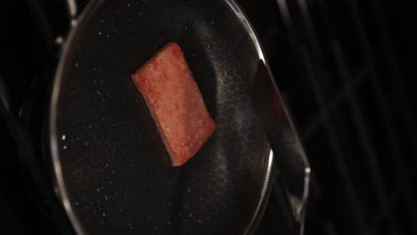 Spatula-Cooking-Slice-of-SPAM-Meat-in-Stainless-Steel-Pan,-Vertical