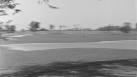 Man-and-Woman-Play-Golf-on-a-Sunny-Summer-Day-in-1930s