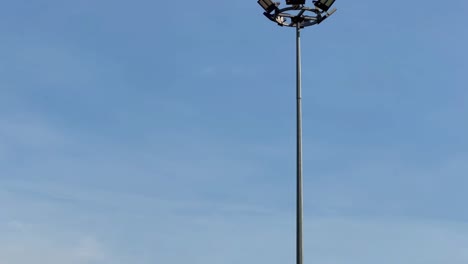 a-single-led-spot-light-close-up-in-a-stadium-during-blue-sky