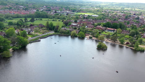 Aerial-panning-down-Petersfield-Heath-Pond-Sunny-day-UK-4K