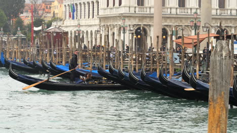 Many-Gondola-Boats-Moored-At-Dock-In-Venice-Town,-Italy