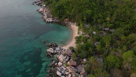 Drone-flight-over-stunning-tropical-bay-with-jungle-backdrop