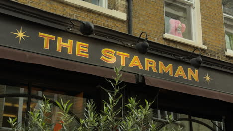 Close-up-of-The-Starman-pub-sign,-Heddon-Street,-London,-Day