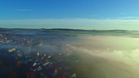 Fog-over-a-countryside-suburban-community-in-Germany---aerial-flyover
