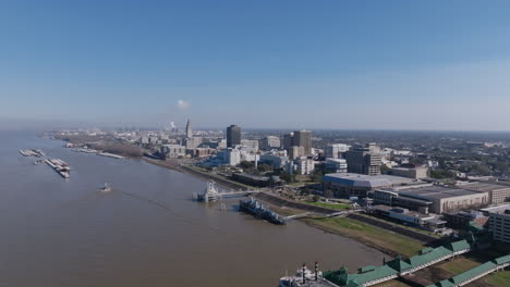 Wide-aerial-footage-of-the-casino-boats-docked-on-the-shore-of-the-Mississippi-River-in-Baton-Rouge,-Louisiana