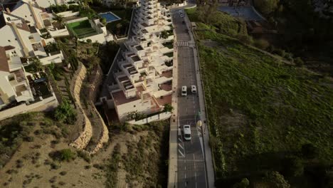 Unveiling-an-aerial-vista-of-Malaga's-residential-expanse,-unveiling-a-panoramic-vista-stretching-to-the-sea-horizon,-evoking-the-essence-of-travel-and-exploration