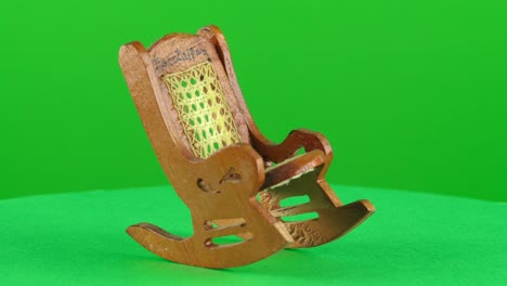 Miniature-mini-scale-wooden-rocking-chair-handmade-handcraft-in-a-turntable-with-green-screen-for-background-removal-3d