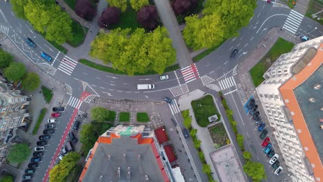 A-white-van-is-driving-through-a-large-roundabout