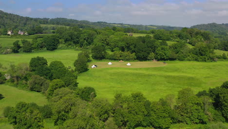 Aerial-wide-panning-of-Great-Oaks-Glamping-Sunny-day-UK-4K