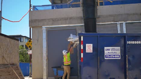 man-throws-a-way-trash-into-dumpster