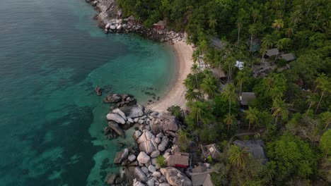 Aerial-tilt-down-reveal-of-beautiful-beach-on-tropical-island