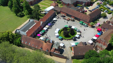 Aerial-flying-over-Ashford-Hangers-market-Sunny-day-UK-4K