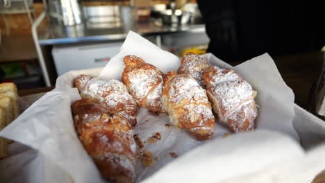 Fresh-croissants-with-powdered-sugar-on-bakery-paper