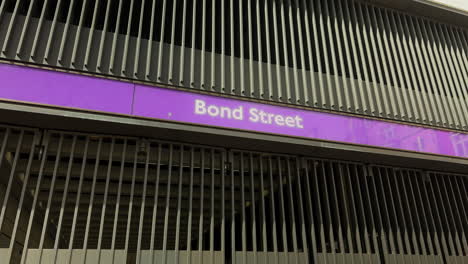 Bond-Street-Overground-station-sign-mid-shot-exit-Russell-Square-London-Day-Exterior