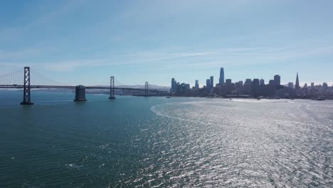 Drone-shot-flying-towards-downtown-San-Francisco-with-the-Oakland-Bridge