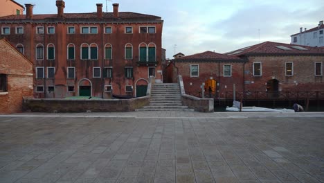 Stone-Bridge-near-Water-Canal-in-Venice-During-Dusk-in-Early-Spring