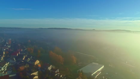 German-village-shrouded-in-misty-fog---aerial-flyover