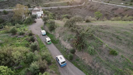 Aerial-tracking-of-camper-vans-traversing-the-scenic-landscape-of-Malaga,-Spain,-embodying-the-spirit-of-travel,-exploration,-freedom,-and-leisure