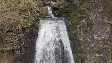 An-aerial-view-of-Melinclourt-Waterfall-on-an-overcast-day,-Neath-Port-Talbot,-South-Wales