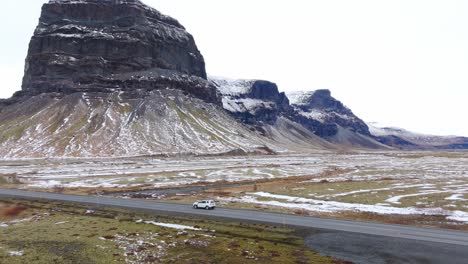Cars-drive-at-Iceland-volcanic-mountain-landscape-panoramic-fly-drone-aerial