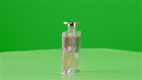 mini-scale-perfume-bottle-elegant-for-mockup-in-a-turntable-with-green-screen-for-background-removal-3d