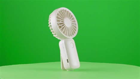 Handy-fan-electric-hand-mobile-ventilator-handyfan-portable-heat-hot-in-a-turntable-with-green-screen-for-background-removal-3d