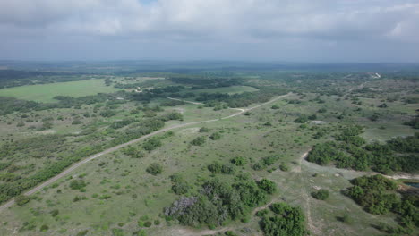Aerial-view-of-a-rural-farm-land-in-the-Texas-Hill-Country-on-a-cloudy-day