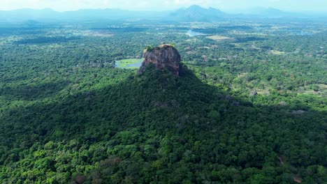 Aerial-drone-landscape-of-Sigiriya-tourism-site-UNESCO-heritage-listed-mountain-rock-formation-in-tropical-rainforest-climate-Sri-Lanka-travel-Asia