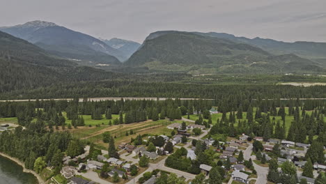 Revelstoke-BC-Canada-Aerial-v3-drone-flyover-residential-area-capturing-Columbia-River,-riverside-golf-club-course-and-forested-mountain-landscape-views---Shot-with-Mavic-3-Pro-Cine---July-2023