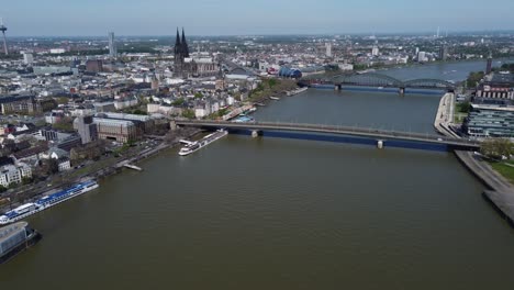 Aerial-Cityscape-of-Cologne-Skyline-on-Sunny-Day,-Establishing-Drone-View