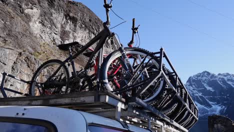 Mountain-bikes-mounted-atop-tour-van,-eco-tourism-in-Bolivia-mountains
